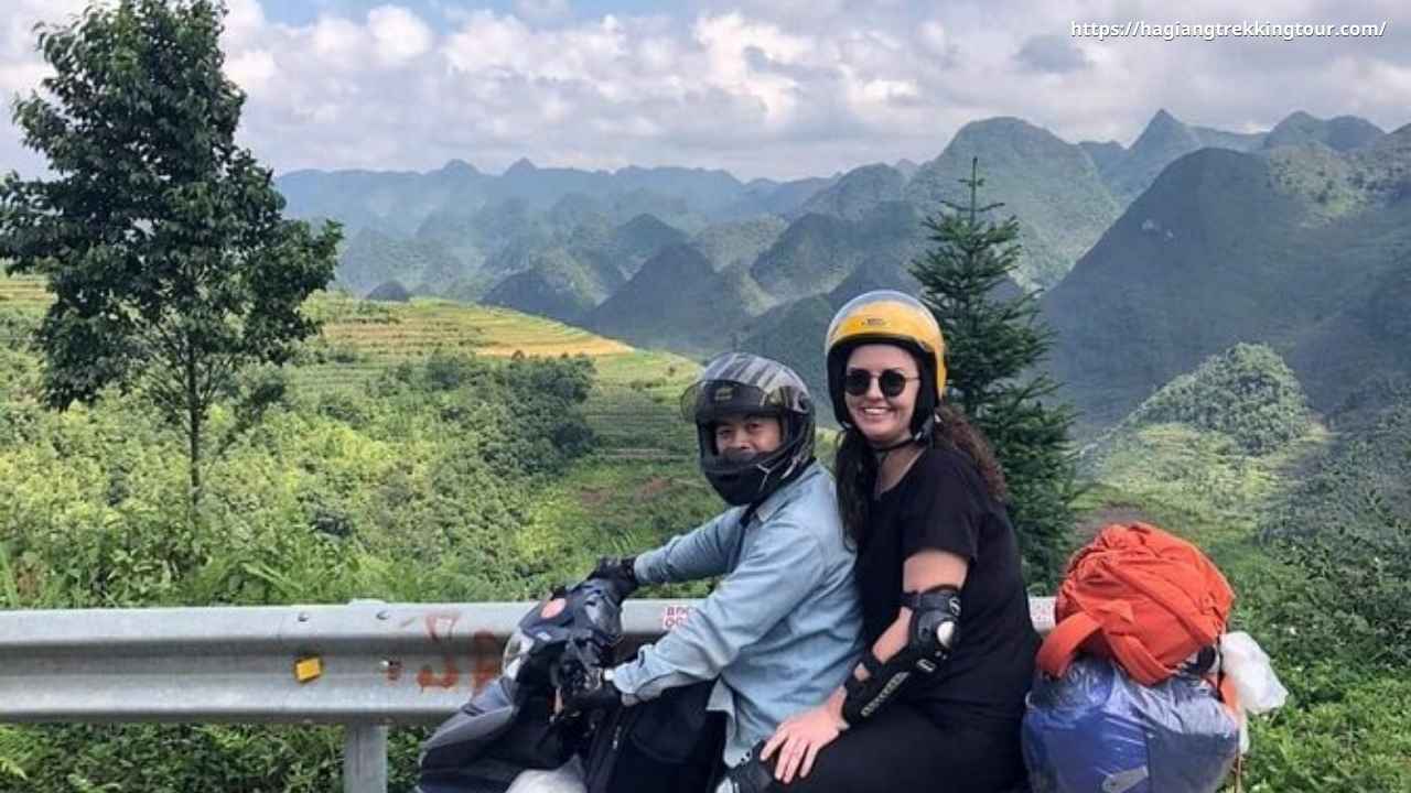 Traveler riding pillion on Easy Rider motorbike through Ha Giang mountain pass